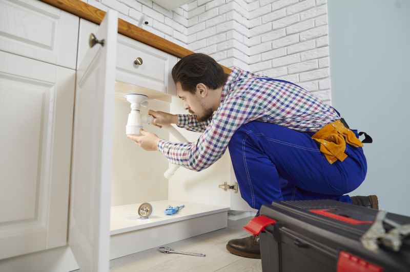 Plumber working on kitchen sink